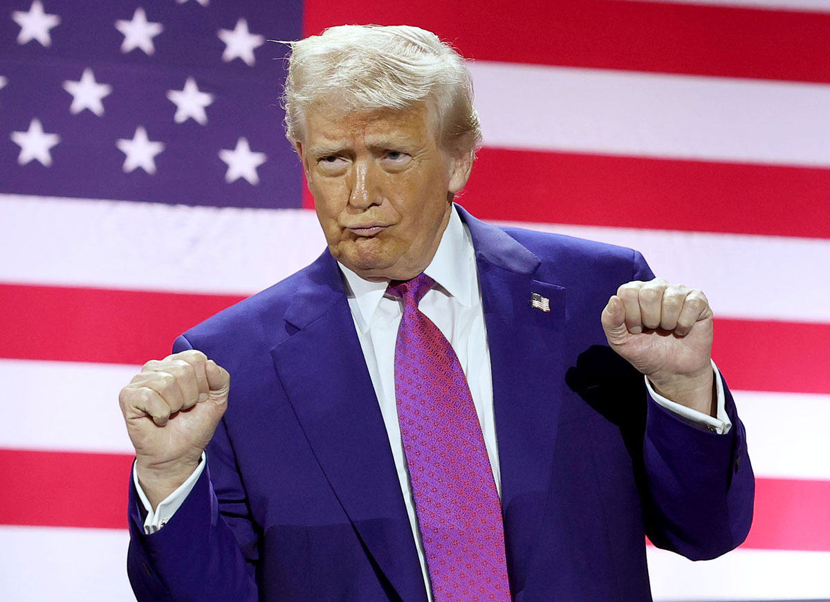 DOHA, QATAR - MAY 15: U.S. President Donald J. Trump gestures on stage as he tours the Al Udeid Air Base on May 15, 2025, in Doha, Qatar. Trump is on the third day of his visit to the Gulf to underscore the strategic partnership between the United States and Qatar, focusing on regional security and economic collaboration. (Photo by Win McNamee/Getty Images)