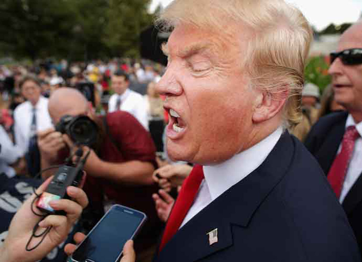 Donald Trump talks to reporters outside White House (Image: Getty)