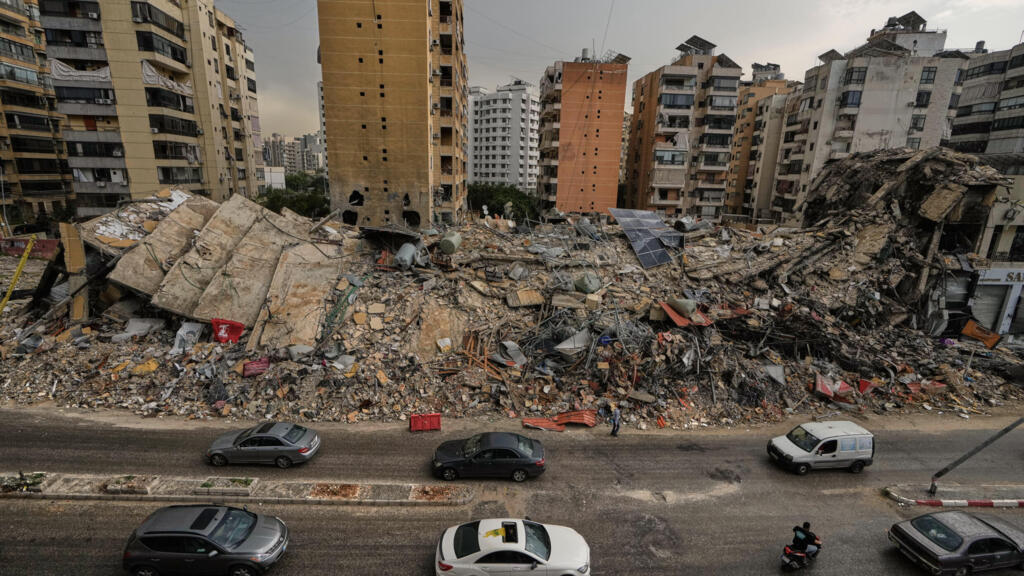 Los residentes pasan en coche junto a los escombros de los edificios destruidos en Dahiyeh, en los suburbios del sur de Beirut, Líbano, el 17 de abril de 2026.