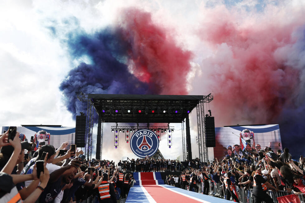 Smoke in the blue and red colours of Paris Saint-Germain billowed over the stage as the players arrived to present the trophy to fans.