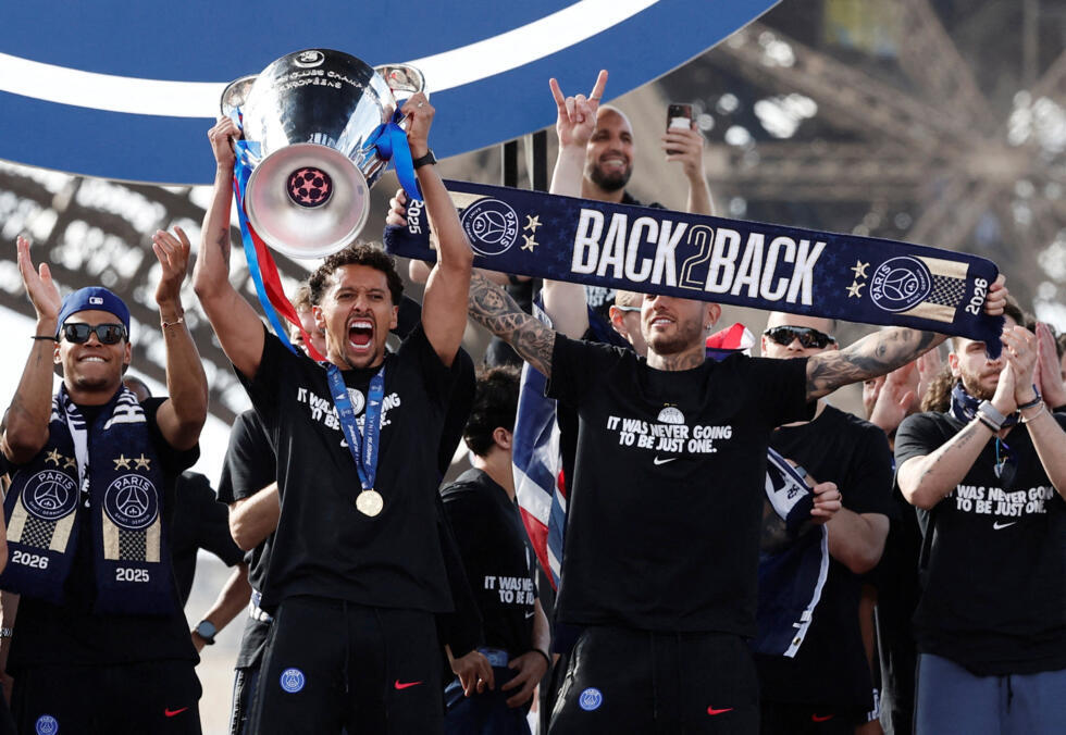 Captain Marquinhos lifts the trophy against the backdrop of the Eiffel Tower.