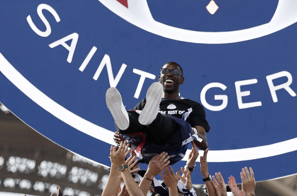 Ballon d'Or Ousmane Dembélé is lifted in the air by his teammates.