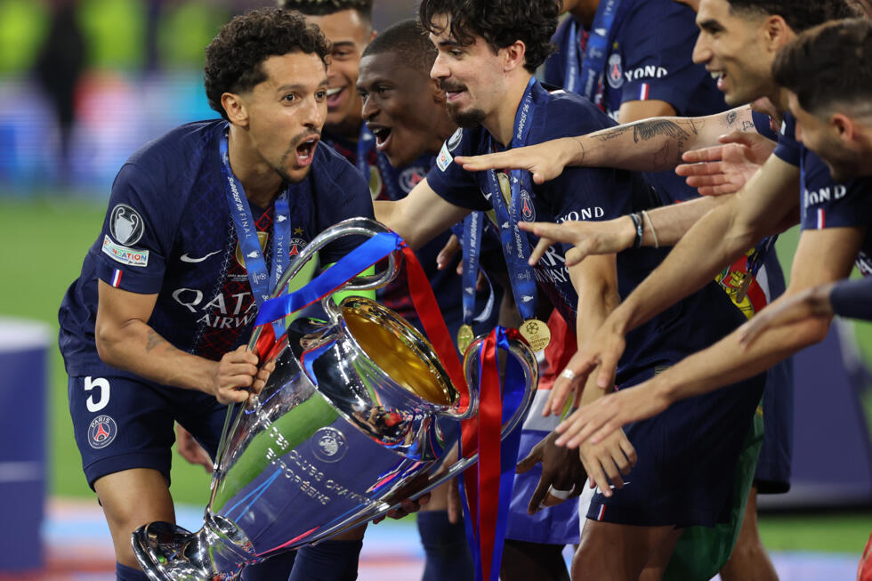 PSG players celebrate with the trophy at the Puskas Arena in Budapest.