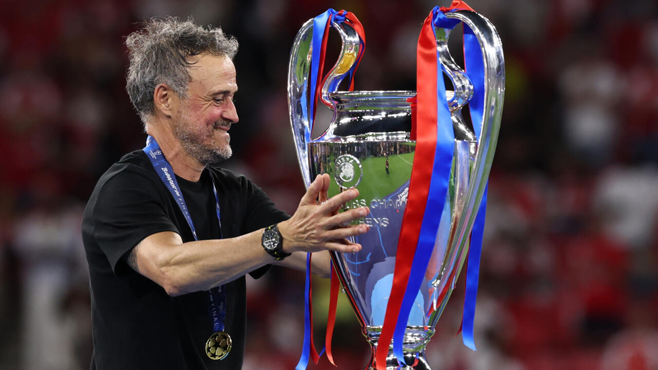 PSG players celebrate with the trophy at the Puskas Arena in Budapest.
