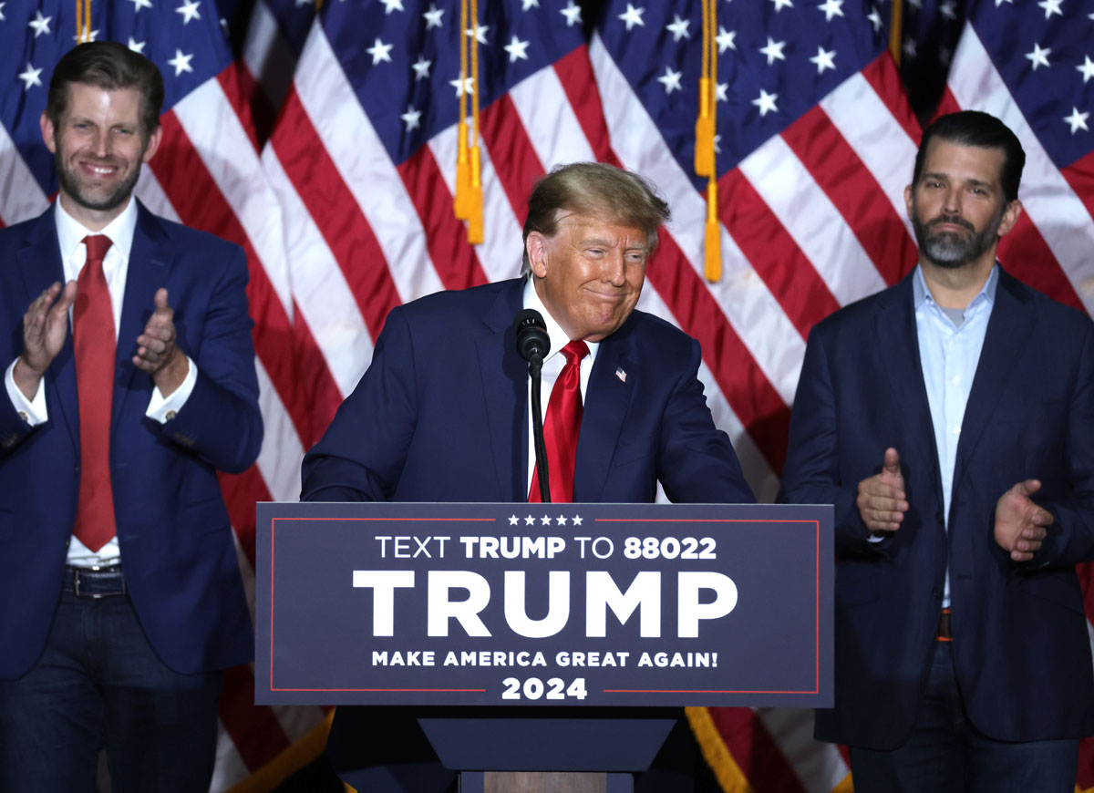 DES MOINES, IOWA - JANUARY 15: Former President Donald Trump speaks at his caucus night event, with sons Eric Trump and Donald Trump Jr. looking on, at the Iowa Events Center on January 15, 2024 in Des Moines, Iowa. Iowans voted today in the state’s caucuses for the first contest in the 2024 Republican presidential nominating process. Trump has been projected winner of the Iowa caucus. (Photo by Alex Wong/Getty Images)