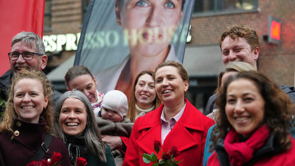 Danish Prime Minister and leader of the Social Democrats Mette Frederiksen, centre, stands with party members at a rally in Copenhagen on March 24, 2026.