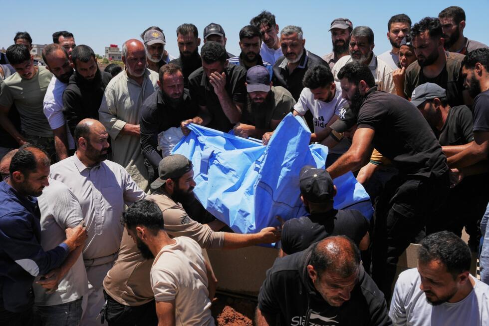 Mourners carry the body of one of the four members of the al-Hariri family killed in Israeli strikes in southern Lebanon in the Daraa province of southern Syria, on June 10, 2026