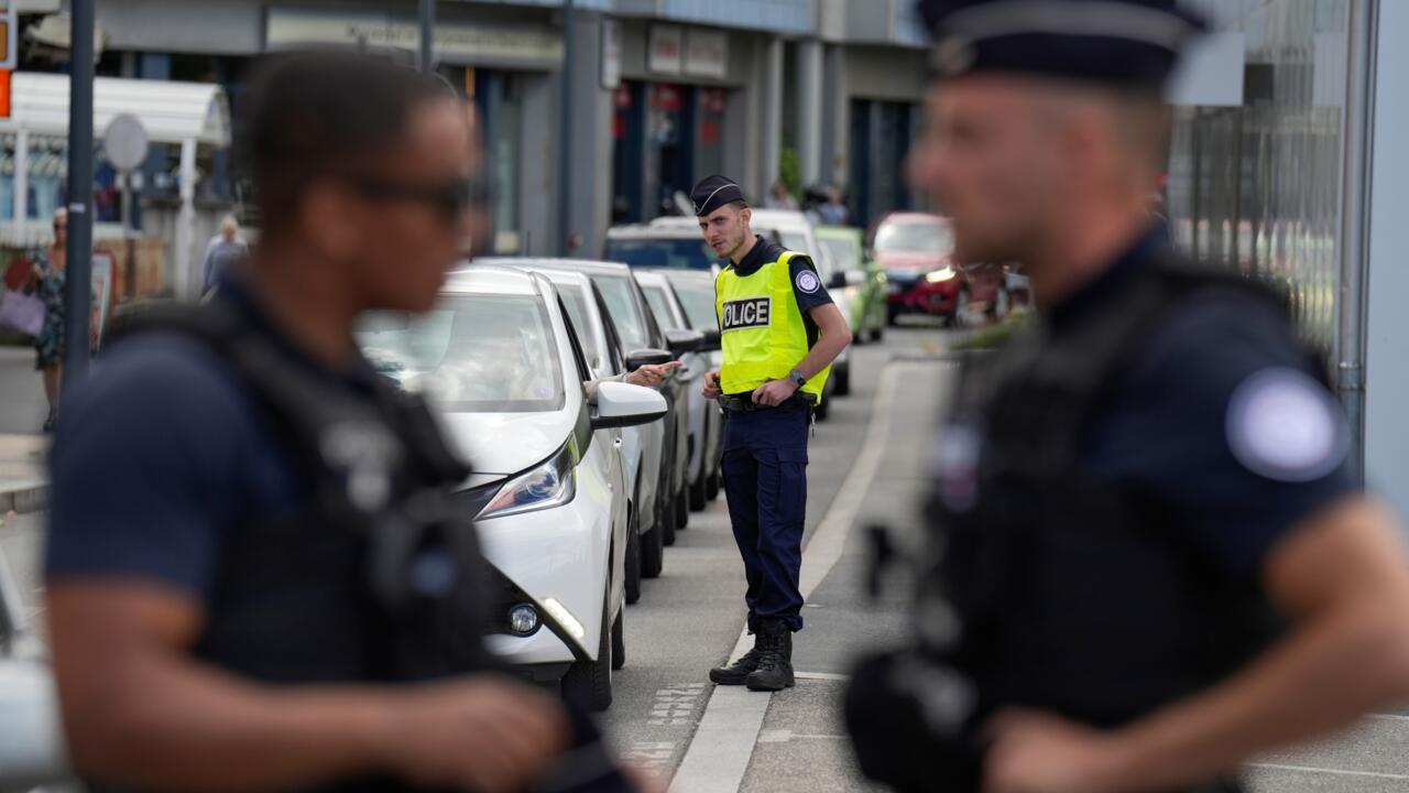 Workers have set up fences to close the border crossing between Switzerland and France in the lakeside village of Hermance