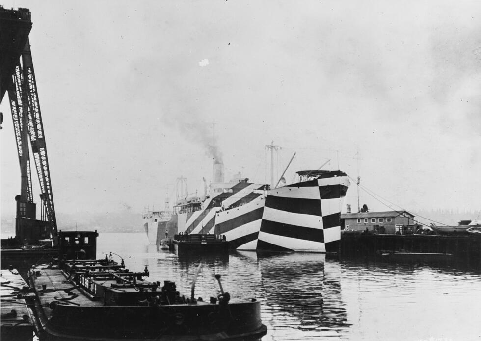 This image shows the USS West Mahomet, used as an auxiliary with the US Navy, covered in a dazzled camouflage in 1918.