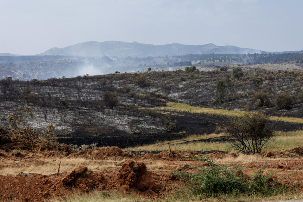 Smoke from a wildfire is seen near the town of Albendiego, in the Guadalajara province north of Madrid, on July 22, 2026.