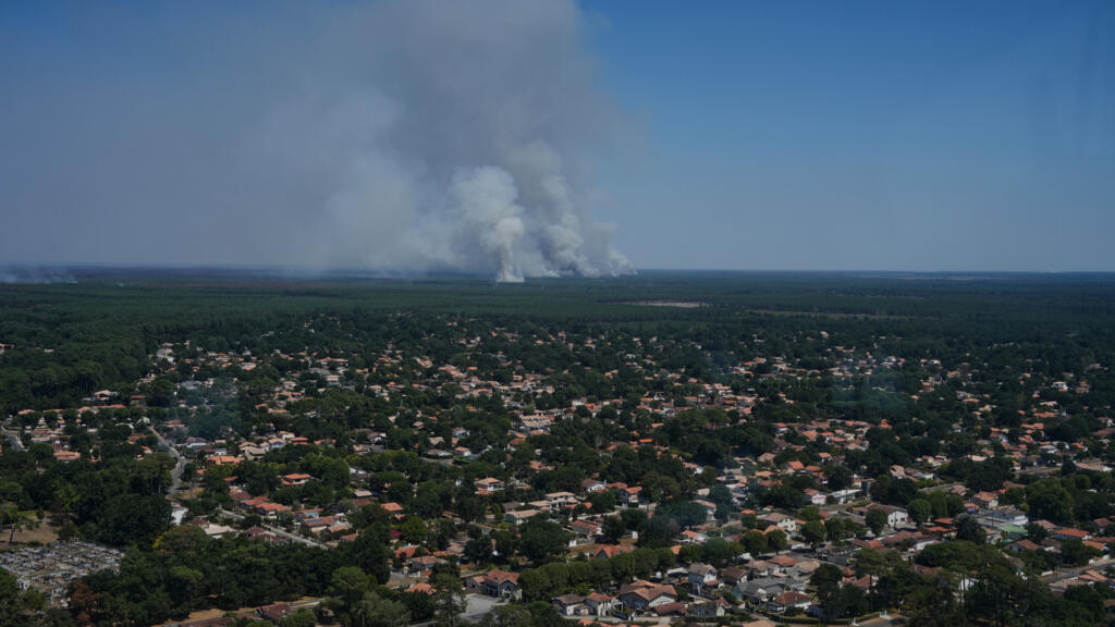 This aerial view taken from a Civil Security helicopter shows plumes of smoke from multiple wildfires near the city of Lège-Cap-Ferret, southwestern France