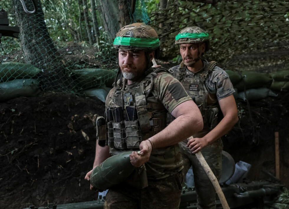 A serviceman of the 15th 'Kara-Dag' Brigade of the Operational Assignment of the National Guard of Ukraine carries a shell.
