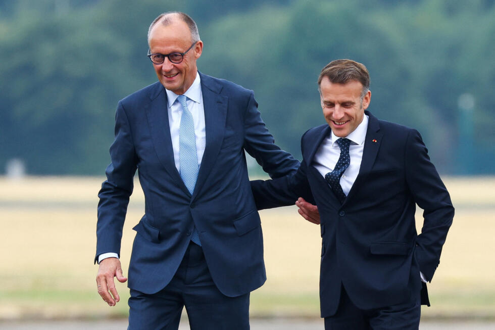 German Chancellor Friedrich Merz and French President Emmanuel Macron arrive for the talks at at the Noervenich air base near Cologne.