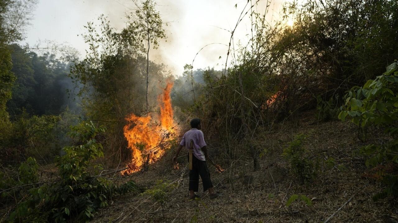 File photo: A member of the Pakanyo tribe set a fire in protected forest land at Chiang Mai province, Thailand, Monday, April 22, 2024.