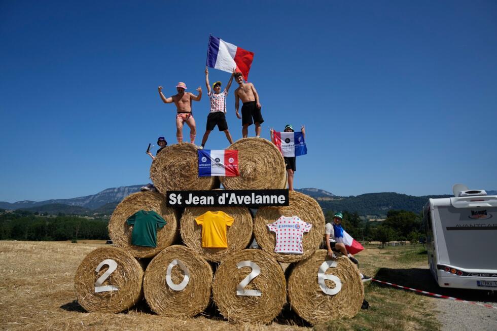Spectators stand on bales of hay during the 17th stage of the Tour de France cycling race, starting in Chambéry and ending in Voiron France, on Wednesday, July 22, 2026.