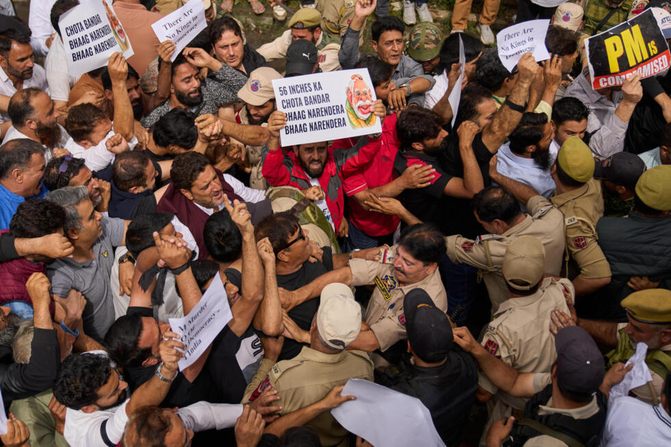 Indian security forces stop members of India's Congress party as they shout slogans during a protest inside the party headquarters in support of the Cockroach Janta Party movement.