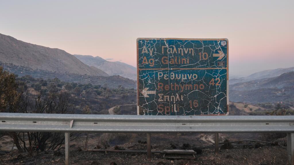 A burned road sign stands amid a burned landscape during a wildfire in the Rethymno region on the southern Greek island of Crete, 29 July 2026.