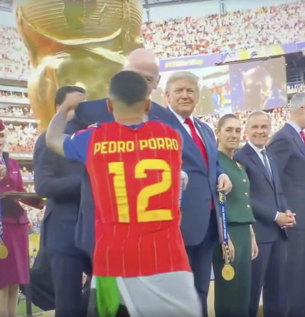 This screengrab shows Pedro Porro getting his medal with a green, white and black flag tied around his waist.