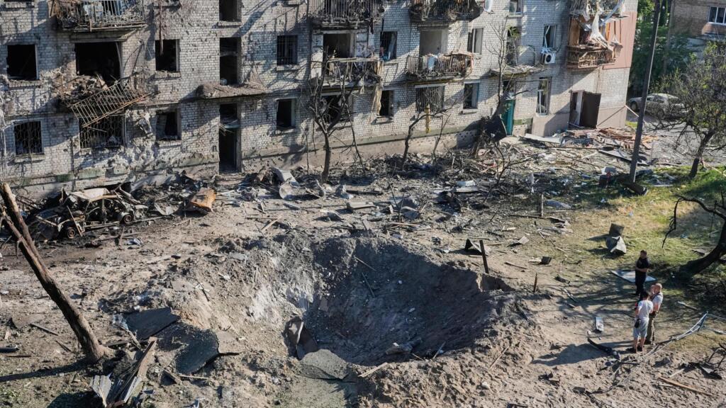 People look at the site of a Russian missile strike that hit a residential building in Kyiv, Ukraine, July 2, 2026. 