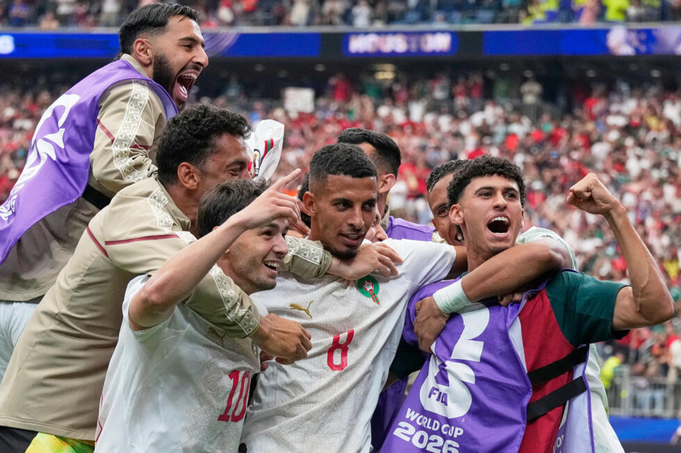 Morocco's Azzedine Ounahi is feted by teammates after scoring a brace against Canada.