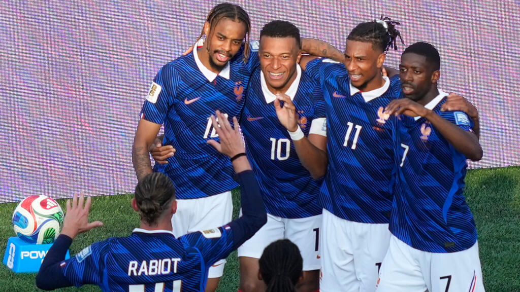 France's Kylian Mbappé (10) celebrates with teammates after scoring his side's third goal during the World Cup round of 32 soccer match between France and Sweden