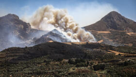 This photograph shows an area engulfed in flames during a wildfire near the village of Asomatos on the Greek island of Crete on July 30, 2026