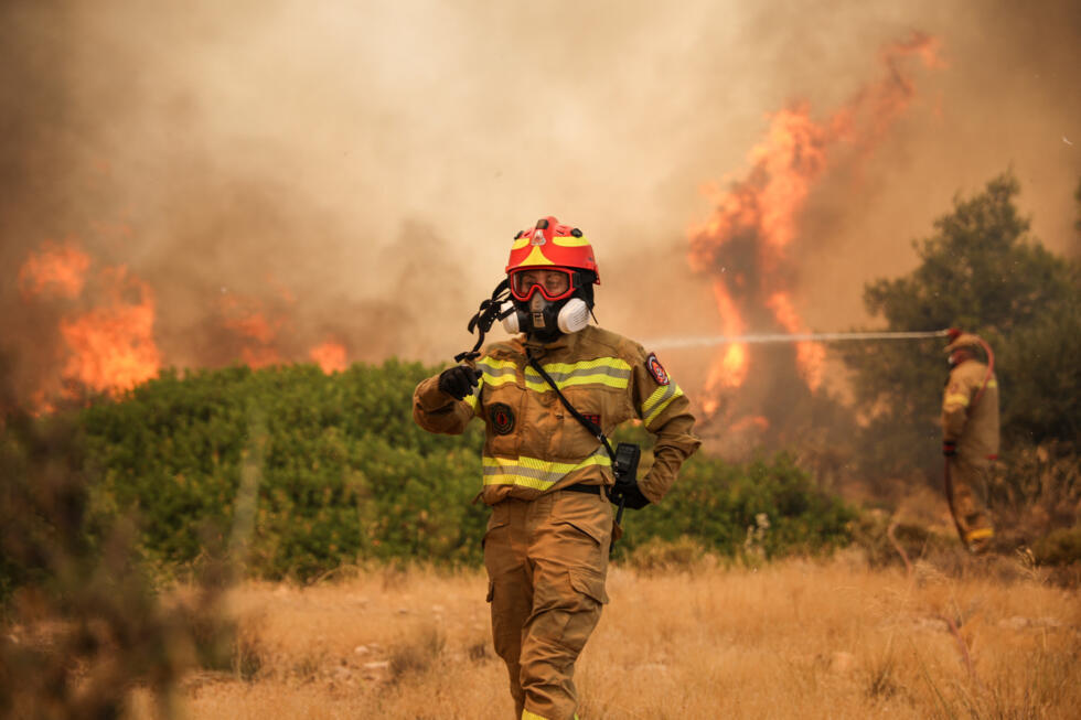 Firefighters work to extinguish a wildfire raging since four days in the Megara Region, west of Athens on August 3, 2026.