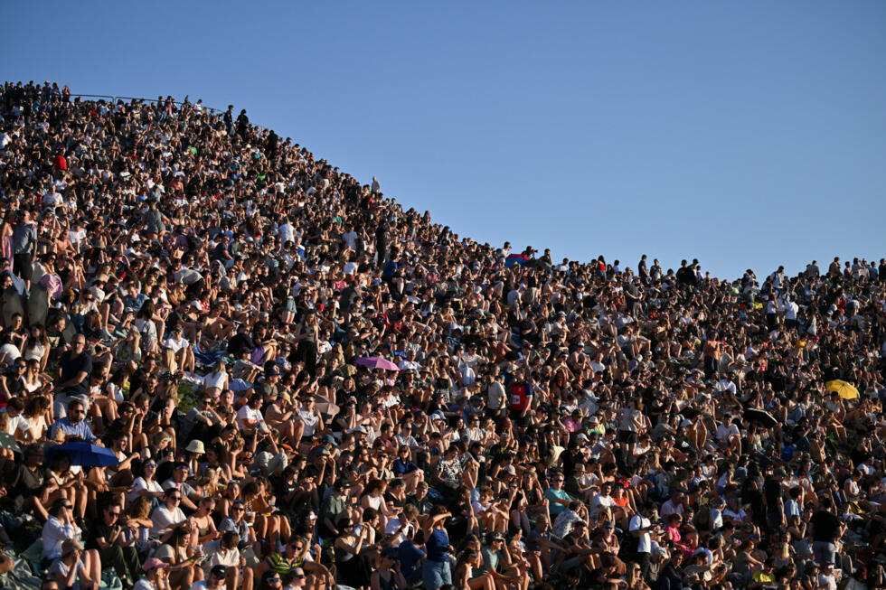 People watch the solar eclipse at Olympic Park in Munich, Germany, August 12, 2026