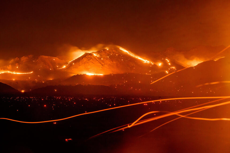 Seen in a long exposure, the Bug Fire burns near Doyle in unincorporated Lassen County, Calif.