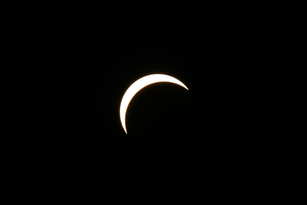 The Moon partially covers the Sun during the solar eclipse as seen from the sidelines of the European Athletics Championships at Alexander Stadium in Birmingham