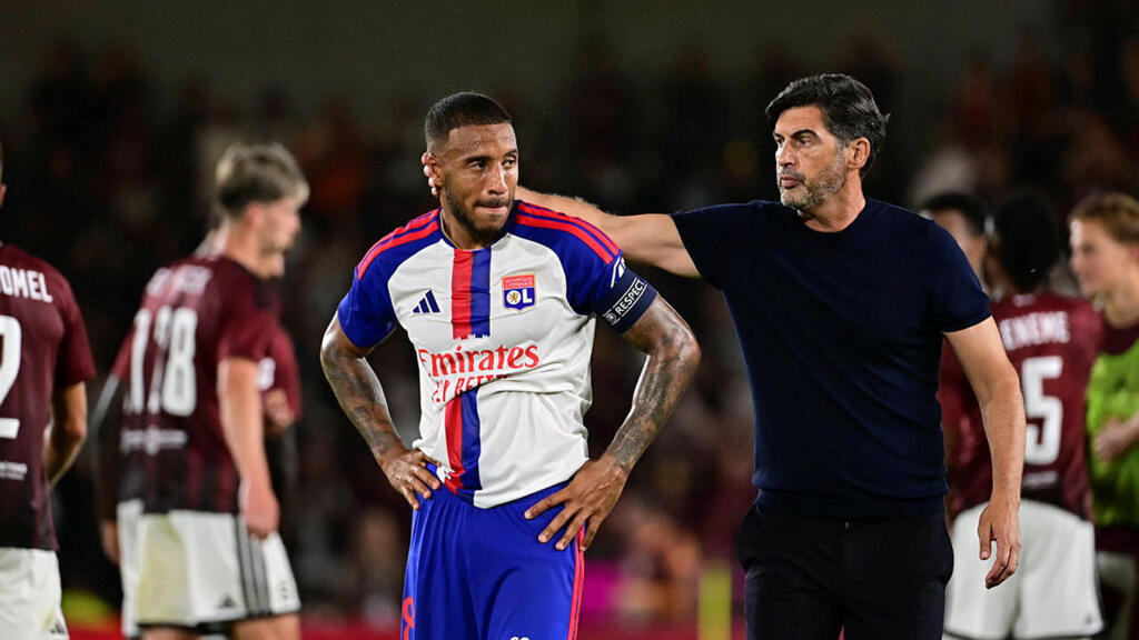 Olympique Lyonnais captain Corentin Tolisso is comforted by his manager Paulo Fonseca on August 4, 2026 in Prague