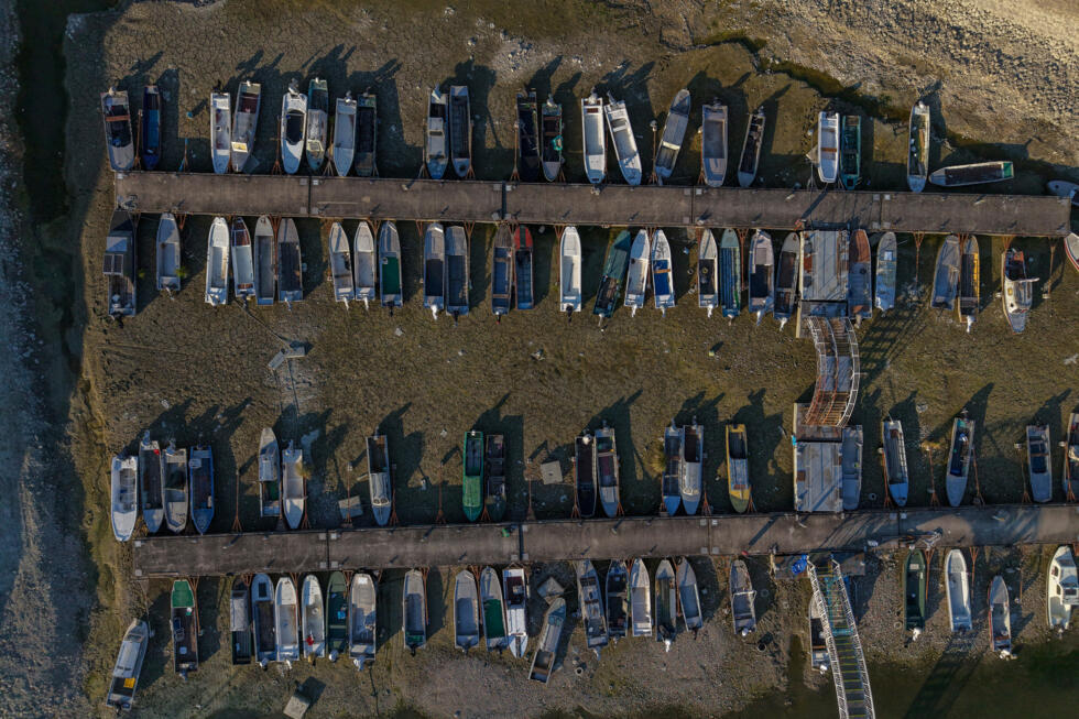 This photo shows boats in a marina left stranded on dry ground by the low water level of the Danube River near Apatin, Serbia, on August 4, 2026.