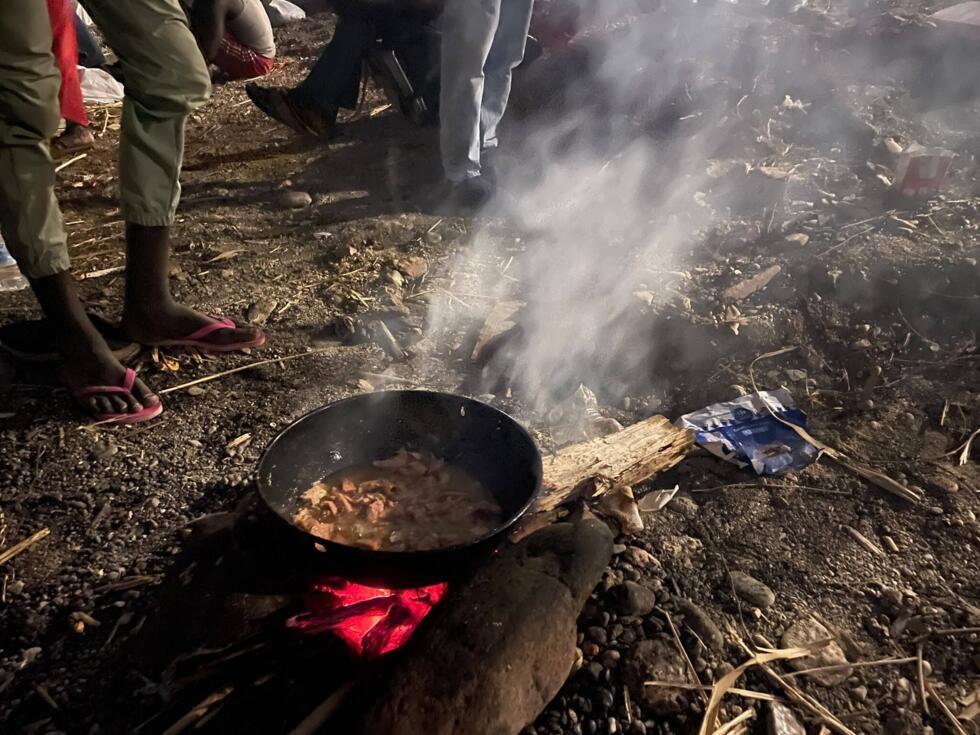 Migrants from sub-Saharan Africa prepare a meal on El Trampoline beach in Ceuta, August 15, 2026
