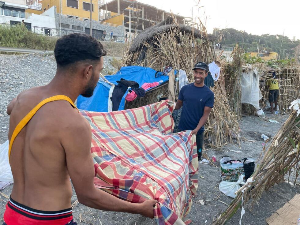 Moroccan migrants wash their tent on El Trampolin beach, Ceuta, on August 15, 2026
