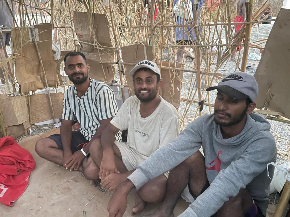 Abdelmajid (centre) and his fellow Yemeni migrants share a makeshift shelter on El Trampolin beach in Ceuta, August 15, 2026